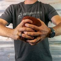 Man compressing a jacket into a tight ball to show packability.