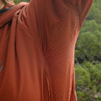 Close-up of the Outdoor Vitals Vario Jacket showing the perforated underarm vents with arms raised