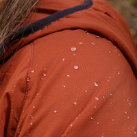Close-up of the Outdoor Vitals Vario Jacket shoulder with water droplets beading on the fabric
